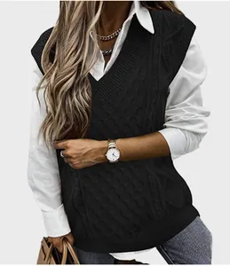 Detail of classic cable knit texture and V-neckline on this black knitted vest for women