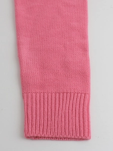 Women's pink long sleeve knit sweater with ribbed cuffs and soft wool-like texture
