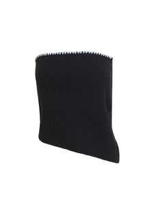 Detail of black knit tube top featuring white wavy trim and asymmetrical hem design