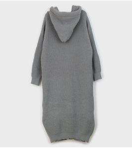 Detail view of the chunky knit texture and hood design on a long grey sweater dress