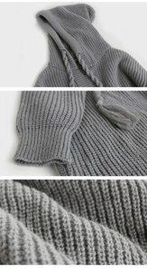 Detail view of grey knit sweater hood with tassels and ribbed cuff texture