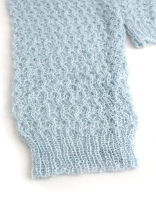 Details von hellblauem Strickcardigan mit Wellenmuster-Hohlstrick und geripptem Bündchen