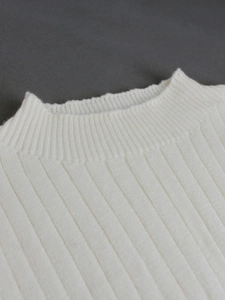 Close-up of white ribbed knit sleeveless sweater dress with round neck detail
