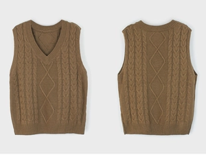 Detail of V-neck knitted sweater vest with cable knit pattern and ribbed hems