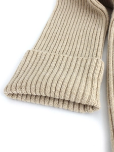 Off-shoulder beige knit sweater with vertical ribbed texture and snug sleeve cuffs
