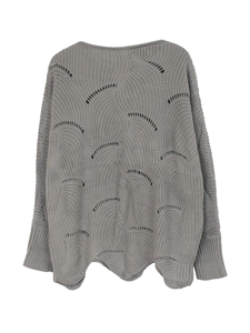 Detailed view of grey knit sweater featuring intricate hollow-out fish scale patterns