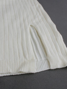 Women's sleeveless white knit dress featuring a ribbed texture and stylish side slit detail