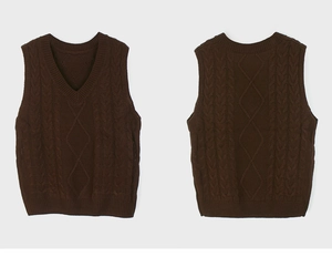 Detail of dark brown cable-knit texture and V-neckline on a sleeveless sweater vest