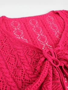 Bright pink knit cardigan featuring hollow-out floral crochet and V-neck tie-up detail