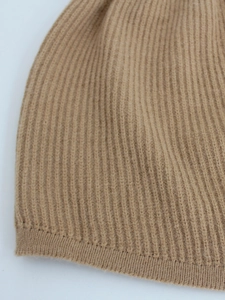 Macro detail of camel rib-knit texture with thick premium fibers and clean edges