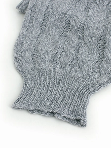 Women's grey cable knit sweater featuring thick texture and ribbed cuff detail