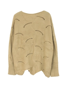 Detailed view of women's beige knit sweater with scallop cutouts and ribbed cuffs