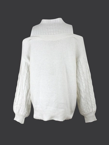 Close-up of white cable-knit sweater with cold-shoulder cutouts and ribbed high neck details