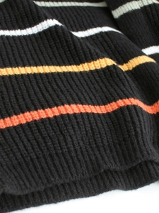 Women's long sleeve black knit cardigan with colorful horizontal stripes and ribbed texture