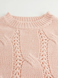 Pink chunky cable knit sweater with crew neck and intricate braided texture detail
