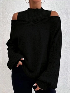 Detail of black knit sweater with cold-shoulder cutouts and cable-knit texture