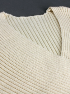 Slim fit V-neck ribbed knit sweater dress in beige featuring soft textured fabric