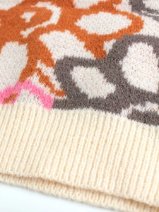 Detailed macro view of the knitted texture with colorful geometric jacquard and ribbed hem