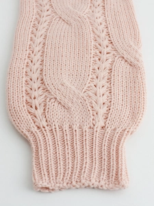Close-up of pink cable knit texture and ribbed cuff on a soft long sleeve sweater