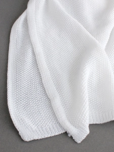 White sleeveless knit maxi dress with a side slit and textured crochet fabric