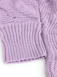 Close-up of lavender knit sweater sleeve with detailed ribbed cuff and textured stitch