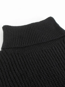 Close-up of the black ribbed knit texture and turtleneck detail on this sweater
