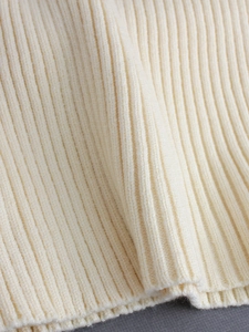Slim fit cream V-neck knit dress featuring premium ribbed texture and soft fabric detail
