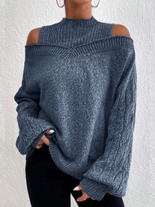 Detail view of navy blue cable knit sweater featuring chic cold shoulder and high collar