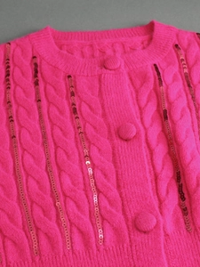 Fuchsia knitted cardigan with cable patterns, matching buttons and shiny sequins decor