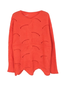Detail of orange hollow knit sweater showing wavy crochet pattern and scalloped hemline
