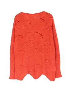 Detailed view of orange knit sweater featuring wave pattern hollow crochet and scallop hem