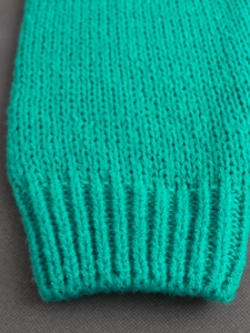 Teal V-neck knit cardigan with ribbed cuffs and soft flat-knit texture details