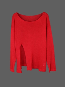 Detail of the oversized red knit sweater featuring unique distressed cutout hem design