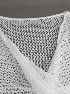 Close-up of white hollow-out mesh knit sweater featuring a V-neckline and crochet texture