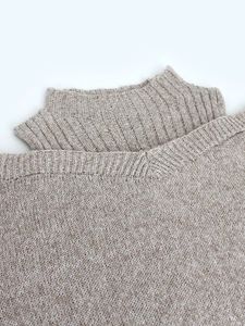 Detail of oatmeal knit sweater with layered high collar and V-neck design for women