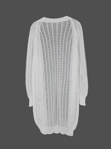 Close-up of white crochet knit cardigan featuring delicate geometric openwork pattern