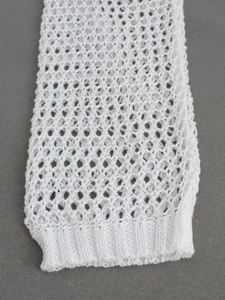 Women's white hollow out knit sweater with long sleeves and ribbed cuffs in minimalist style
