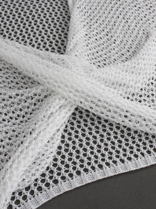 Detailed knit texture of a white backless long sleeve crochet sweater for women
