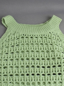 Light green knit tank top featuring a textured hollow mesh pattern and ribbed neckline