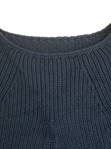 Detailed view of the ribbed round neckline and knit texture on the navy batwing sweater