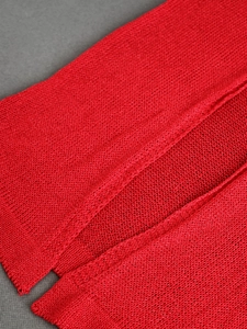 Macro shot of red knitted fabric texture showing fine stitching and soft yarn material