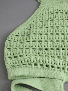 Close-up of light green knit halter top showing intricate hollow geometric textures