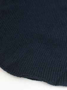 Close-up of high-density navy blue ribbed knit texture and curved hem stitching detail