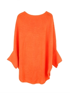 Detail of chunky knit bright orange sweater featuring textured stitching and bell sleeves