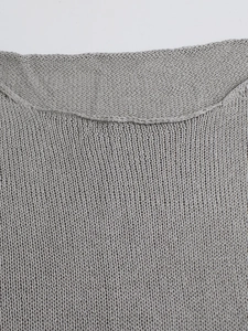 Close-up of the fine knit texture and flat seams on this grey long-sleeve top