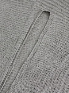 Close-up of gray knit fabric showing the detailed stitching and seamless edge quality