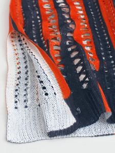 Knit V-neck sweater with flag pattern featuring orange blue and white crochet hollow out details