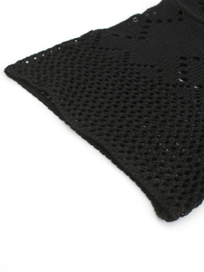 Detail of black pointelle knit fabric with geometric hollow patterns for beachwear