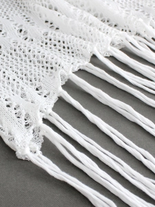 Elegant white crochet off-shoulder midi dress with hollow lace patterns and fringe detail