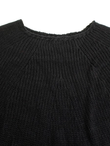 Close-up of the ribbed knit crew neck and texture on this black oversized sweater